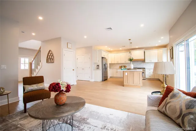 a living room with furniture and kitchen view