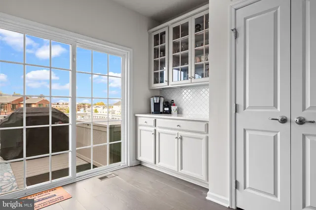 a roof deck with couch and chairs