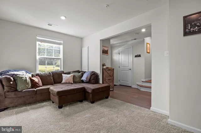 a living room with couches and a bathroom