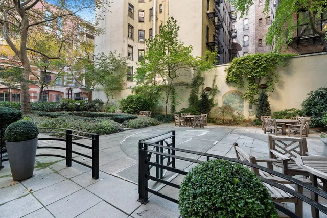 a city street lined with lots of buildings and trees