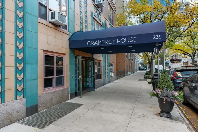 a view of kitchen with a stove top oven and a clock on the wall