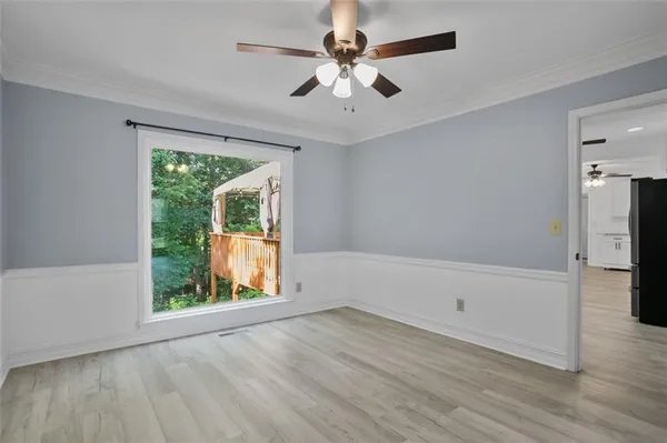 a view of a room with wooden floor and cabinet
