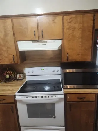 a stove top oven sitting inside of a kitchen