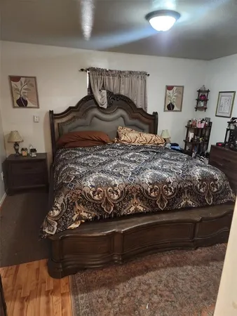 a bedroom with a bed and flat screen tv