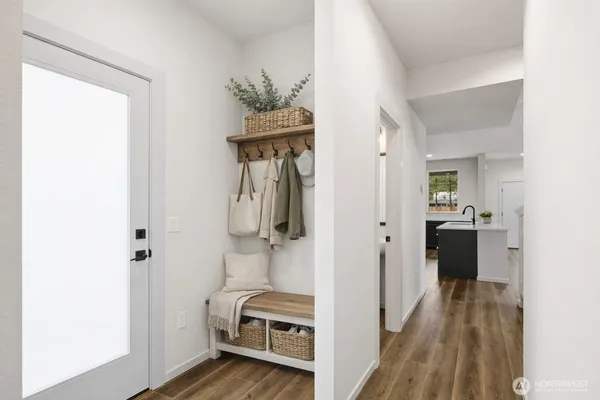 a view of a hallway with wooden floor and closet