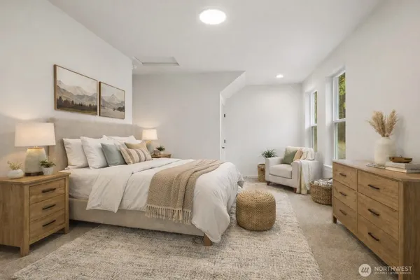 a spacious bedroom with a bed and a couch