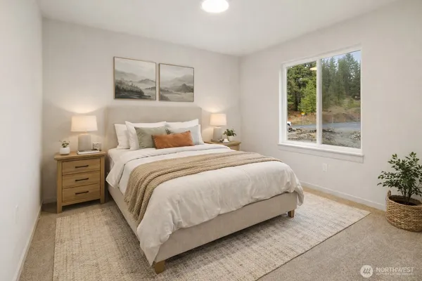 a bedroom with a bed and a potted plant