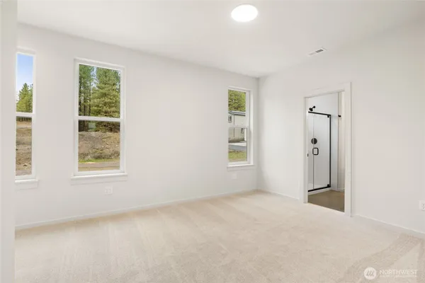 an empty room with windows and closet