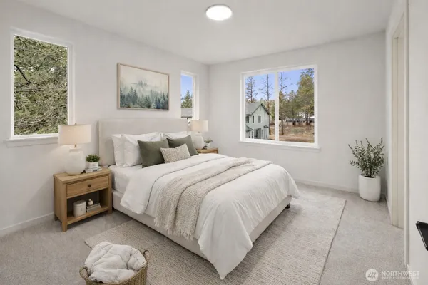 a bedroom with a bed and a large window