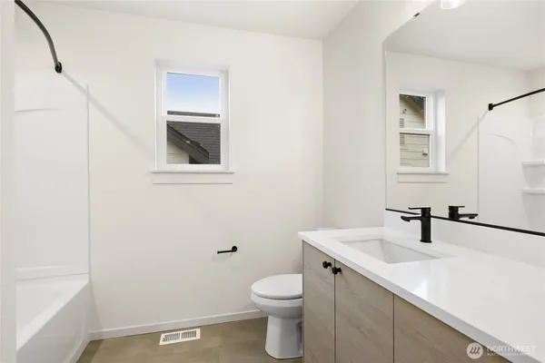 a bathroom with a sink a toilet and vanity