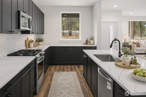 a kitchen with a sink stove and cabinets