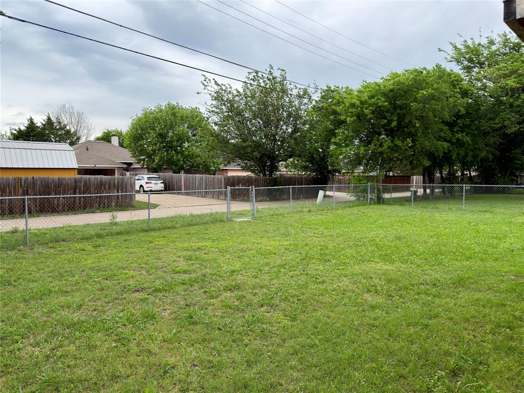 1519 Clearbrook Street Lancaster, TX 75134 - Photo 13 of 29 a view of a yard with a bench