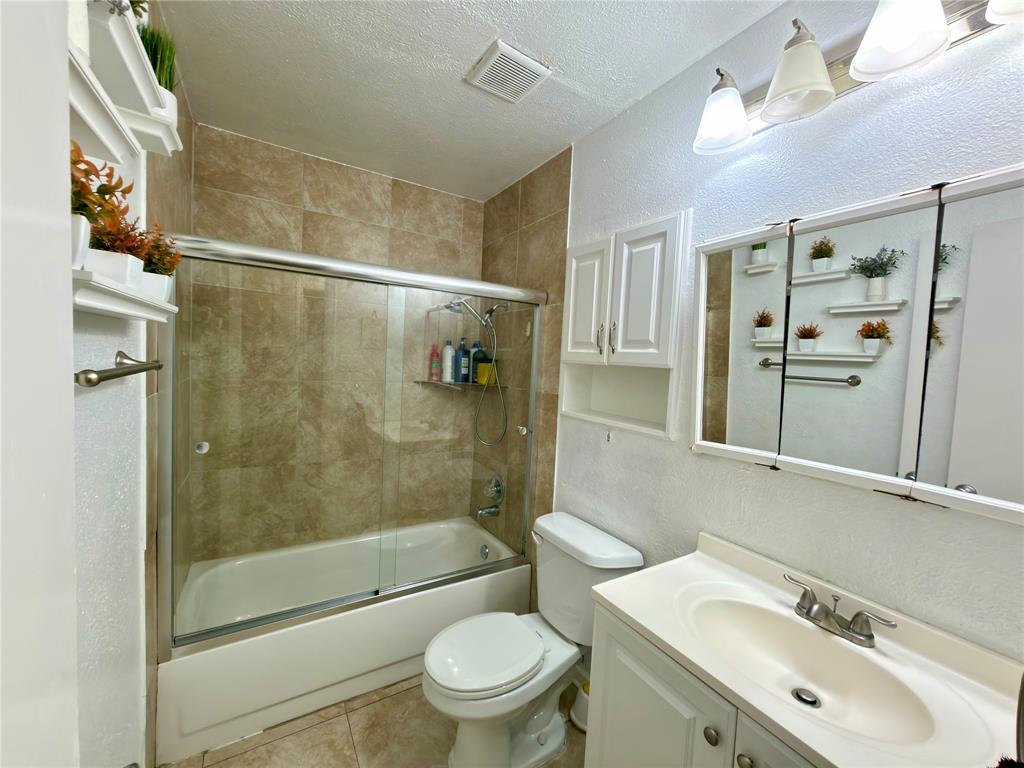 1519 Clearbrook Street Lancaster, TX 75134 - Photo 15 of 29 a bathroom with a sink toilet and shower