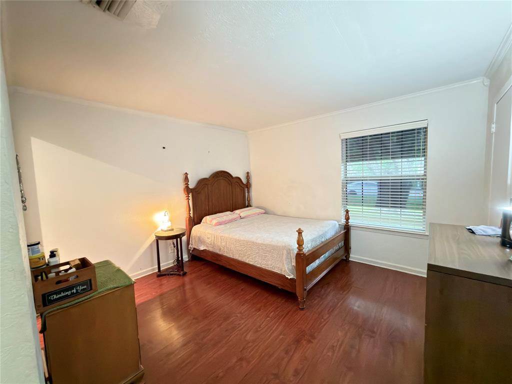 1519 Clearbrook Street Lancaster, TX 75134 - Photo 16 of 29 a bedroom with a bed and wooden floor