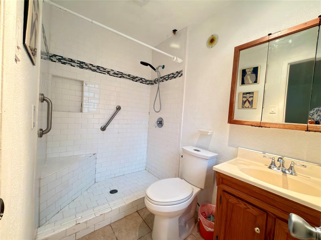 1519 Clearbrook Street Lancaster, TX 75134 - Photo 19 of 29 a bathroom with a sink toilet and shower