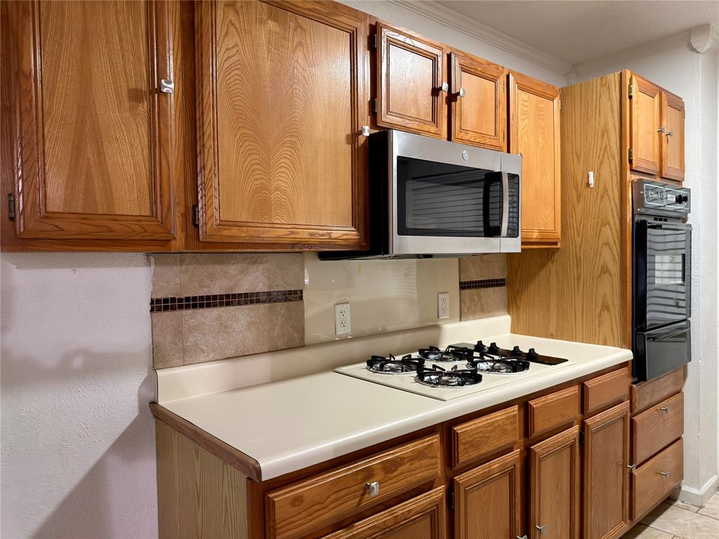 1519 Clearbrook Street Lancaster, TX 75134 - Photo 2 of 29 a kitchen with stainless steel appliances a stove a microwave and sink