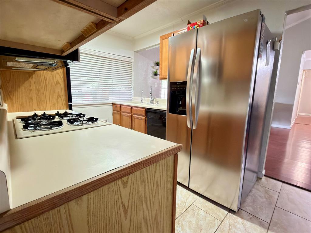 1519 Clearbrook Street Lancaster, TX 75134 - Photo 6 of 29 a kitchen with stainless steel appliances granite countertop a refrigerator and a stove