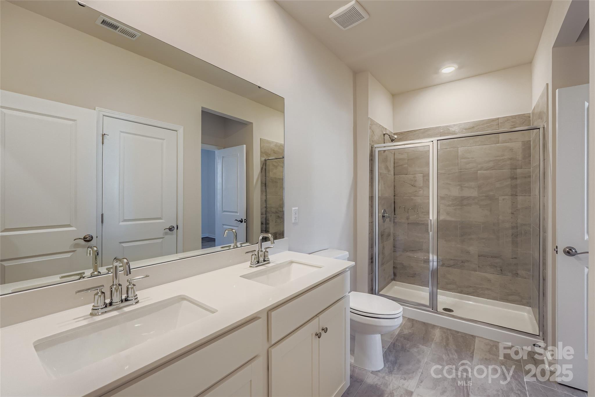 8487 Norman Frst Road Lancaster, SC 29720 - Photo 11 of 16 a bathroom with a shower sink vanity mirror and toilet