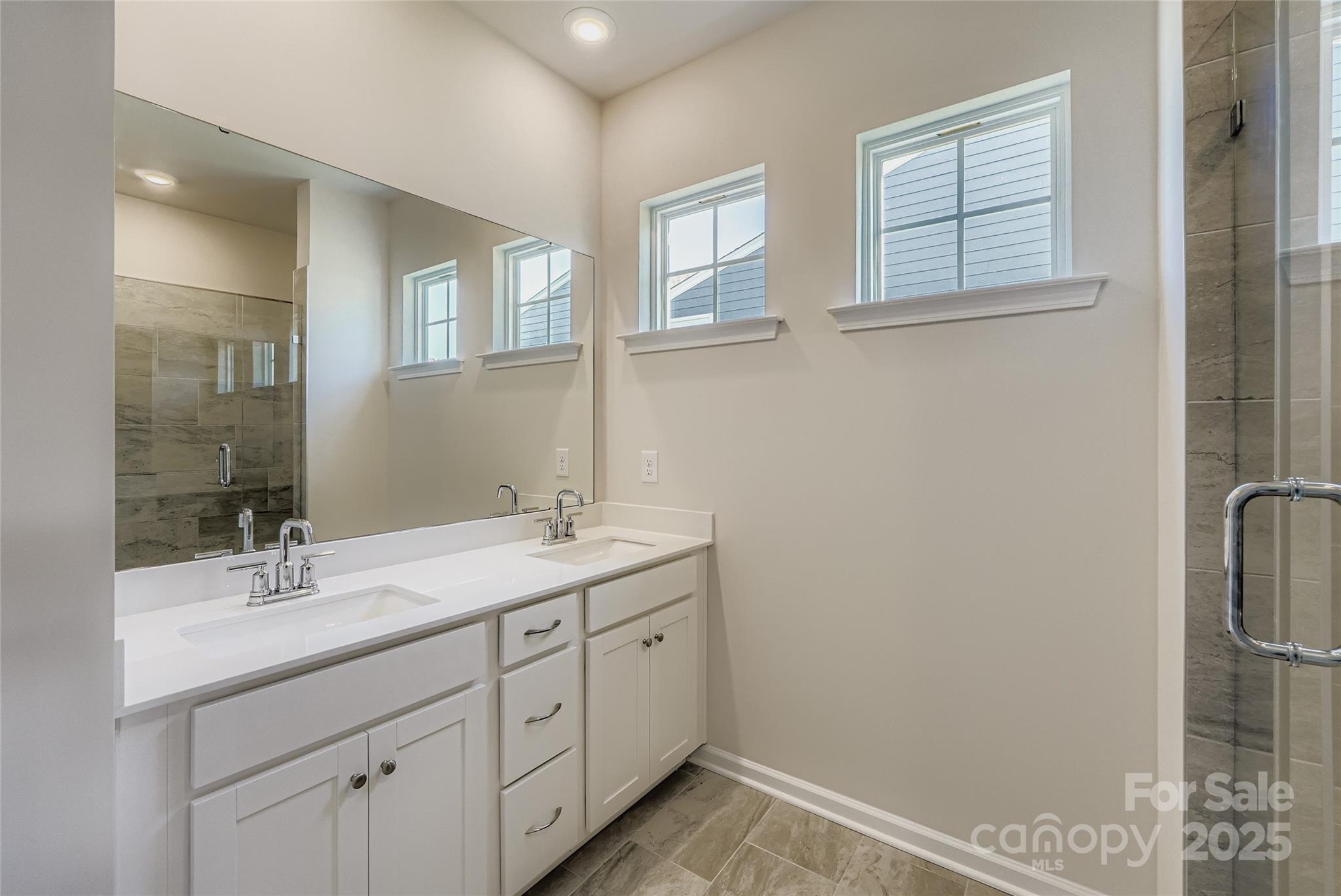 8487 Norman Frst Road Lancaster, SC 29720 - Photo 7 of 16 a bathroom with a double vanity sink and mirror