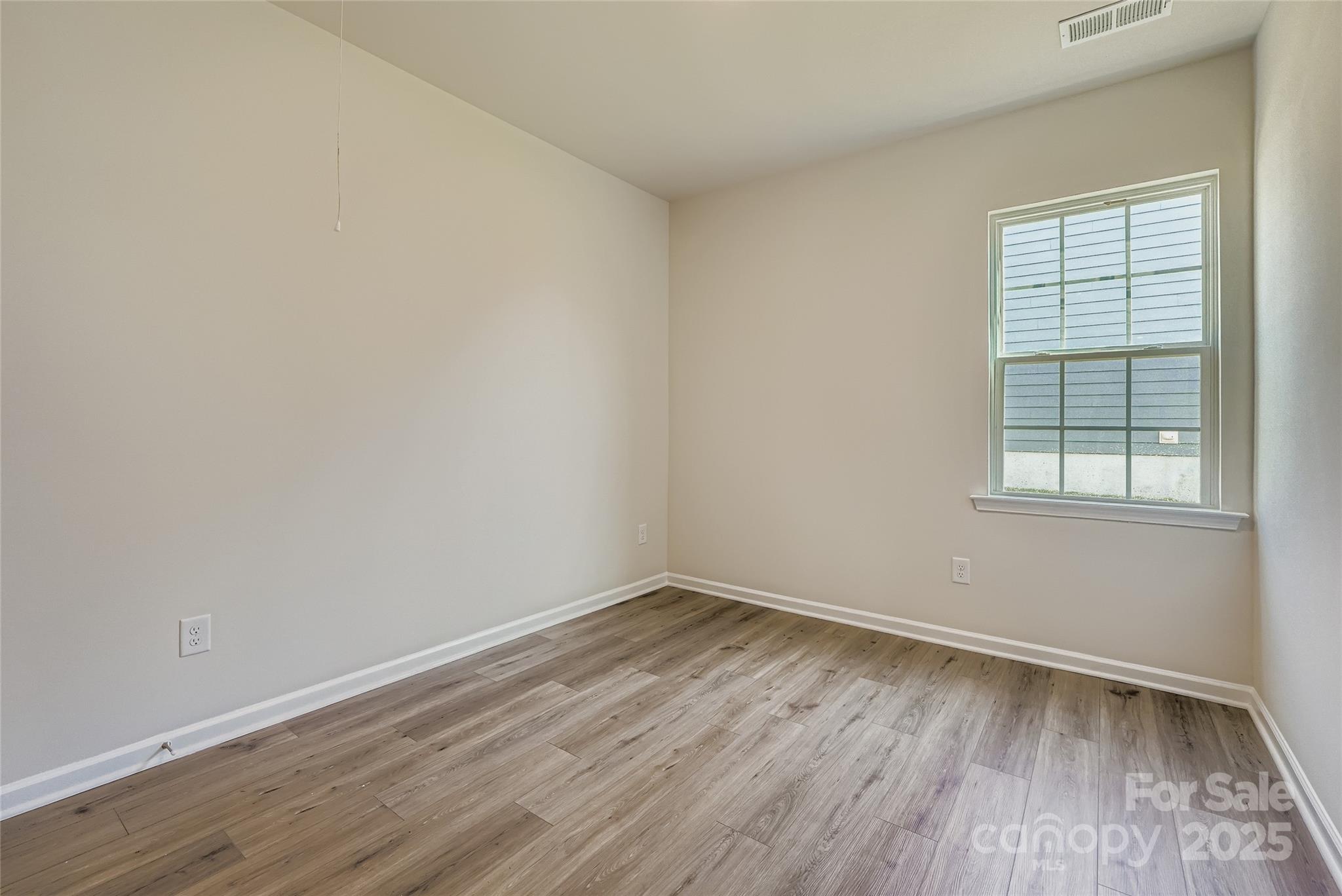 8487 Norman Frst Road Lancaster, SC 29720 - Photo 10 of 16 wooden floor in an empty room with a window