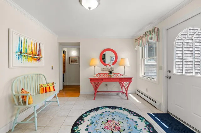 a living room with dining room and wooden floor