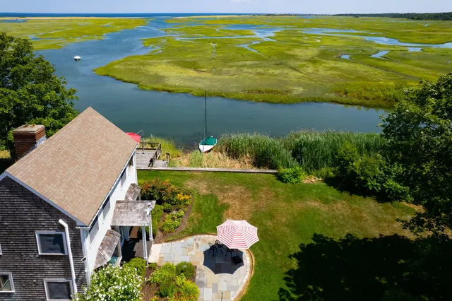 an aerial view of a house with a swimming pool yard and outdoor seating