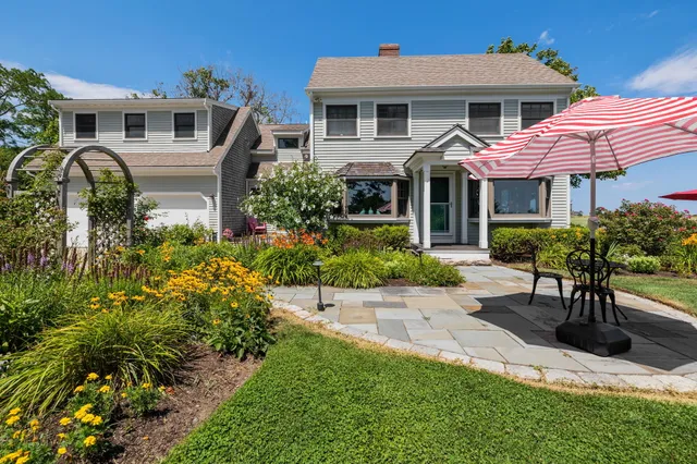 a front view of a house with a garden