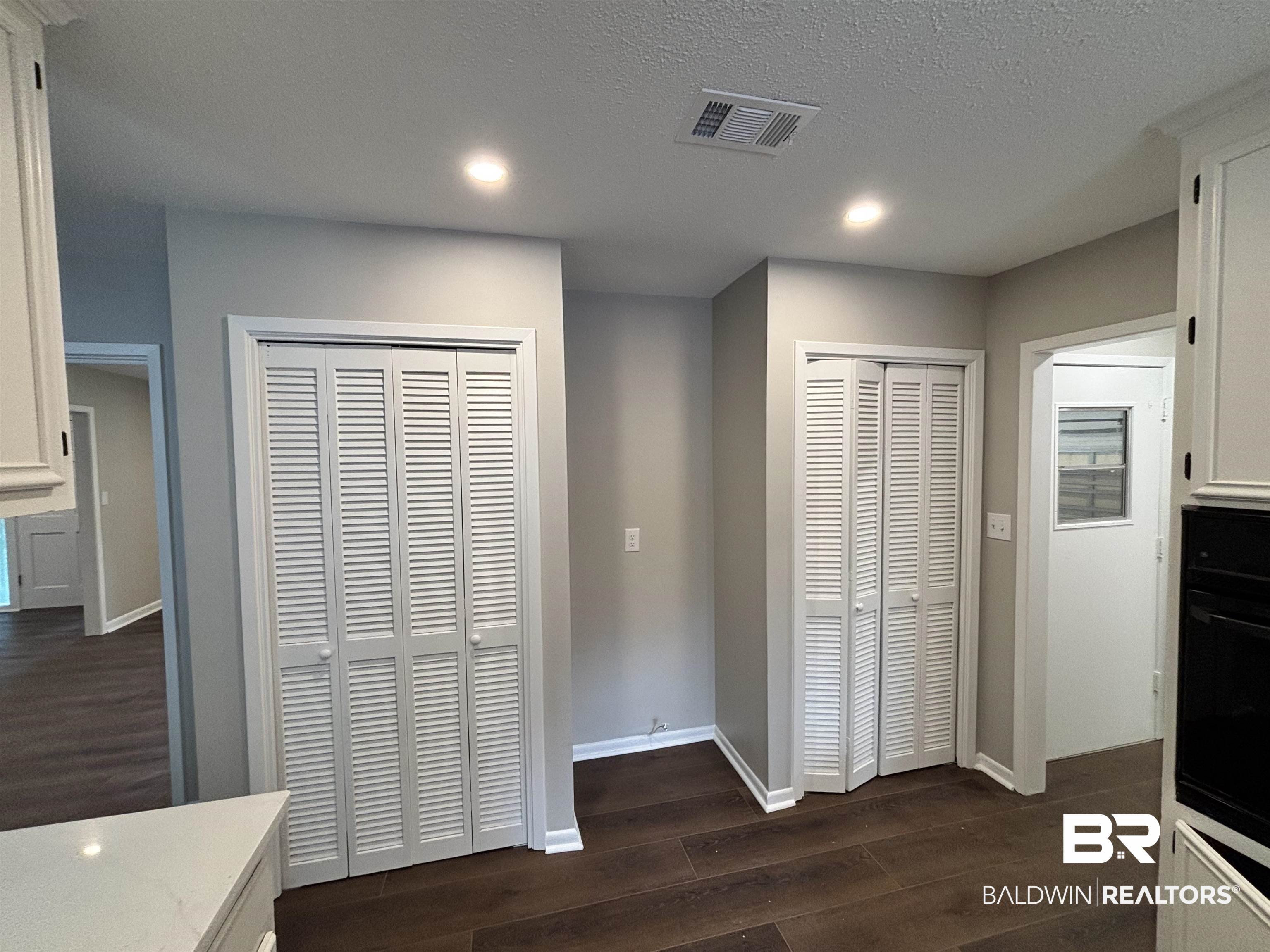 10 Soldiers Route Daphne, AL 36527 - Photo 13 of 26 Kitchen featuring white cabinets, dark wood-type flooring, a textured ceiling, black oven, and recessed lighting
