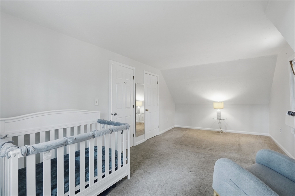 30 Packet Landing, Unit A Pembroke, MA 02359 - Photo 16 of 32 a bed room with furniture and a lamp