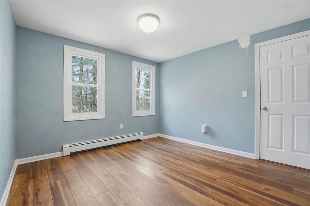 30 Packet Landing, Unit A Pembroke, MA 02359 - Photo 21 of 32 an empty room with wooden floor and windows