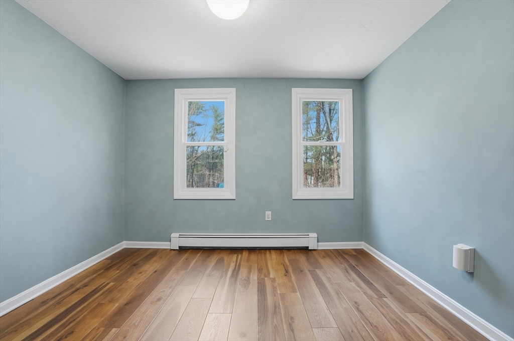 30 Packet Landing, Unit A Pembroke, MA 02359 - Photo 22 of 32 a view of an empty room with wooden floor and a window