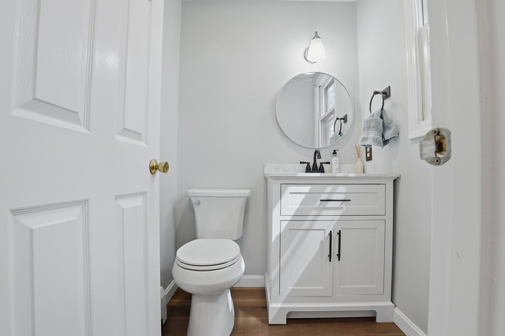30 Packet Landing, Unit A Pembroke, MA 02359 - Photo 24 of 32 a bathroom with a toilet a sink and mirror