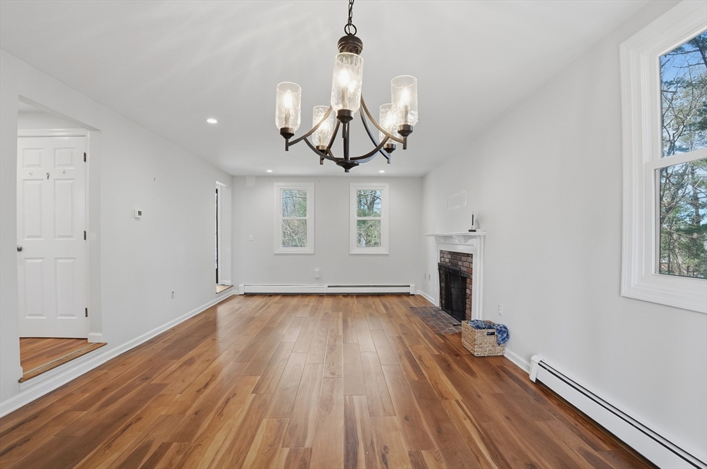 30 Packet Landing, Unit A Pembroke, MA 02359 - Photo 4 of 32 a view of empty room with wooden floor and fireplace