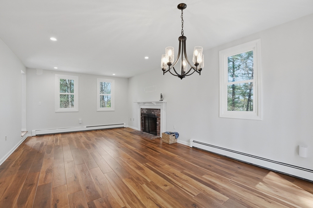 30 Packet Landing, Unit A Pembroke, MA 02359 - Photo 5 of 32 a view of empty room with wooden floor window and fireplace