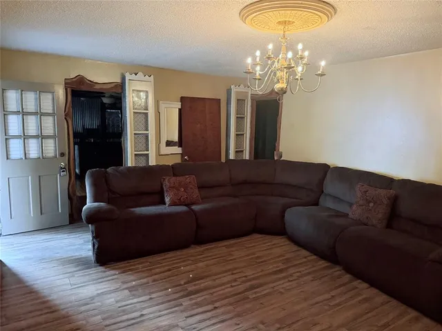 a living room with furniture and a chandelier