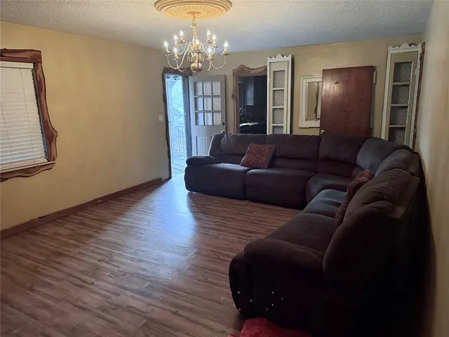 a living room with furniture and a chandelier