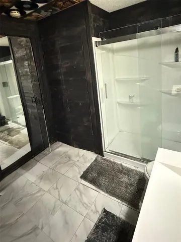 a bathroom with a glass door shower