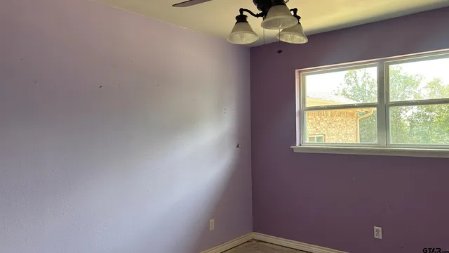 a view of a room with a window and a fan