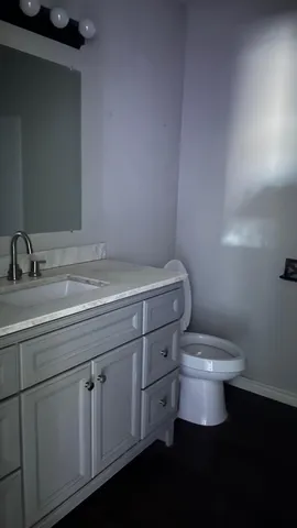 a bathroom with a sink a toilet and a mirror