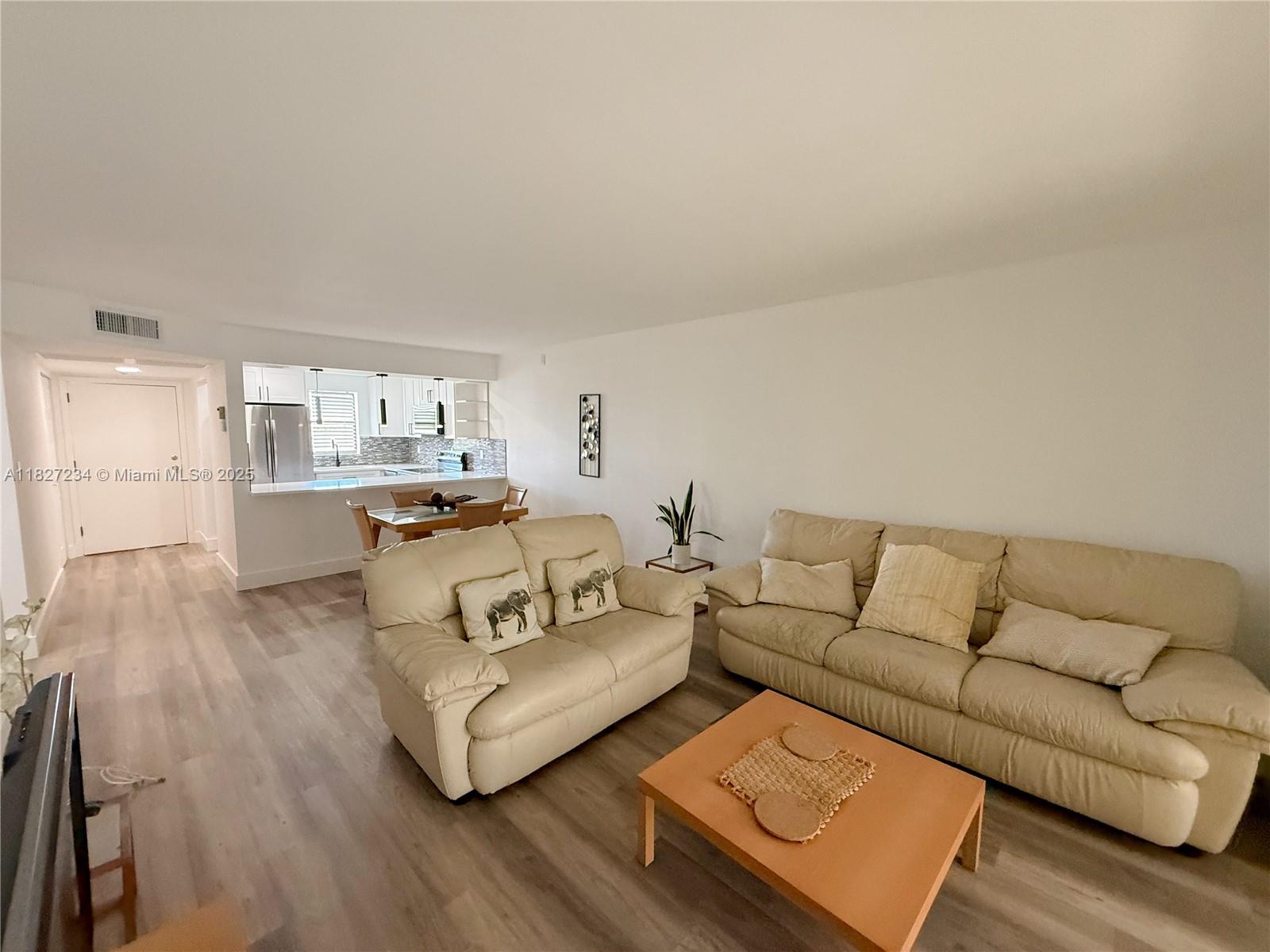 9355 Southwest 8th Street, Unit 402 Boca Raton, FL 33428 - Photo 13 of 29 a living room with furniture and a wooden floor
