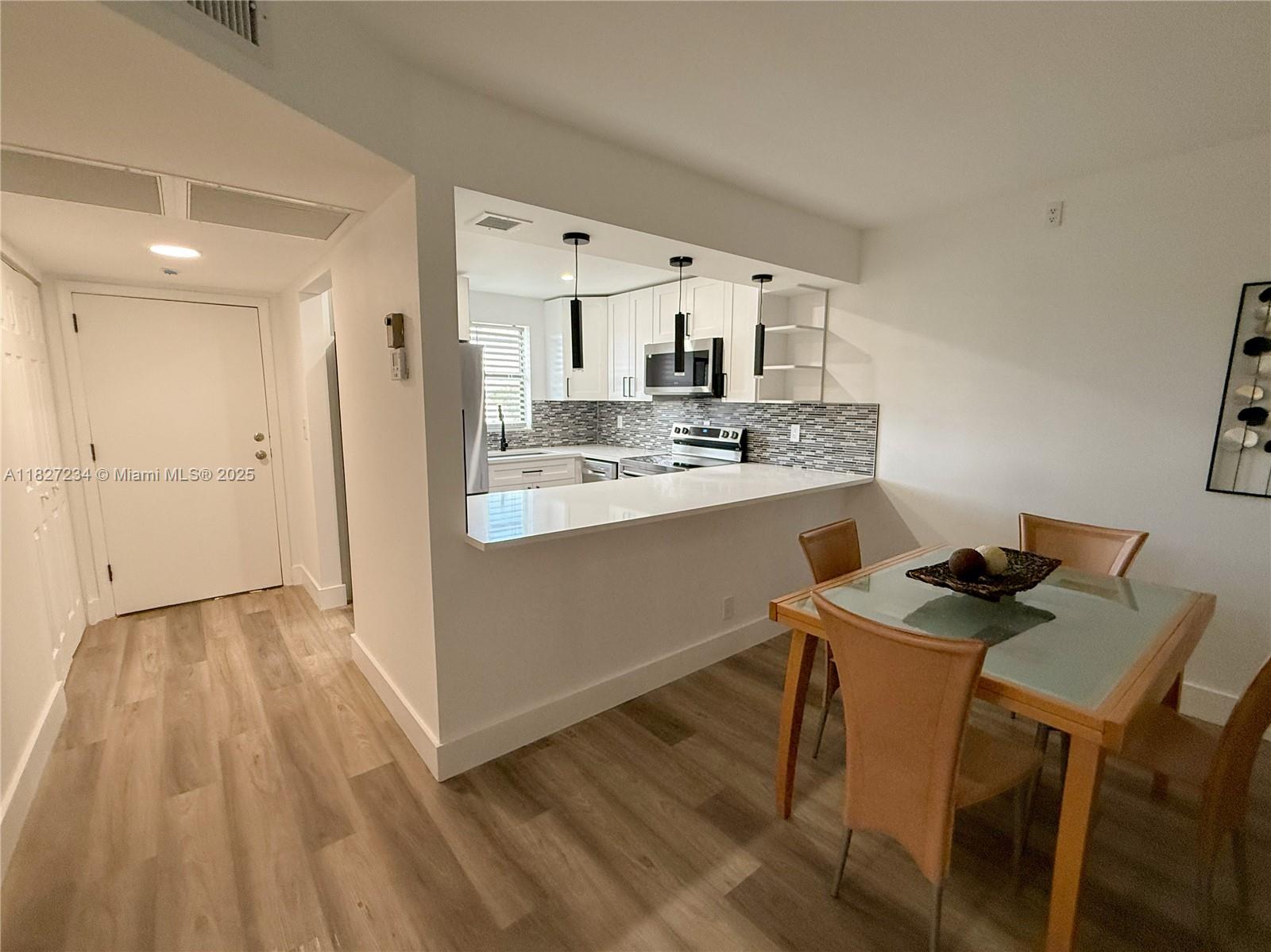 9355 Southwest 8th Street, Unit 402 Boca Raton, FL 33428 - Photo 14 of 29 a kitchen with stainless steel appliances granite countertop a sink stove and refrigerator