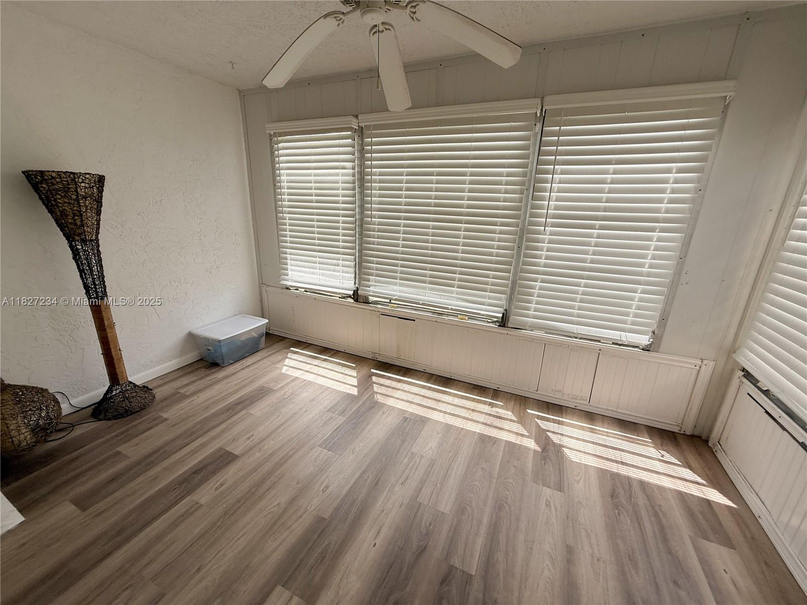9355 Southwest 8th Street, Unit 402 Boca Raton, FL 33428 - Photo 17 of 29 a view of a room with wooden floor and a window