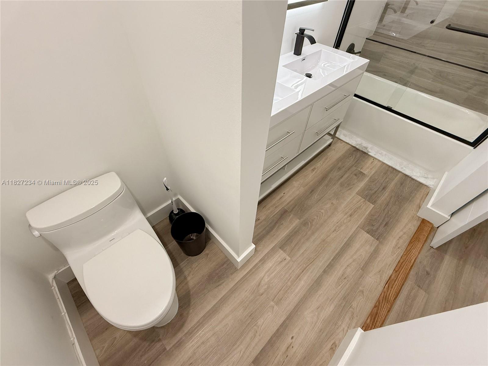 9355 Southwest 8th Street, Unit 402 Boca Raton, FL 33428 - Photo 21 of 29 a bathroom with a sink and mirror