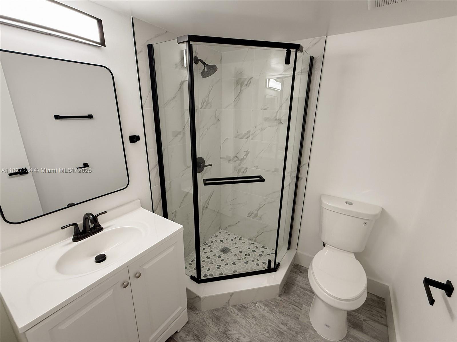 9355 Southwest 8th Street, Unit 402 Boca Raton, FL 33428 - Photo 25 of 29 a bathroom with a sink toilet and shower