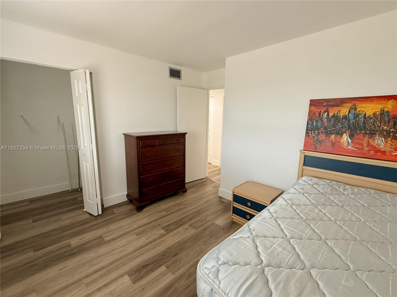 9355 Southwest 8th Street, Unit 402 Boca Raton, FL 33428 - Photo 29 of 29 a bedroom with a bed and a dresser