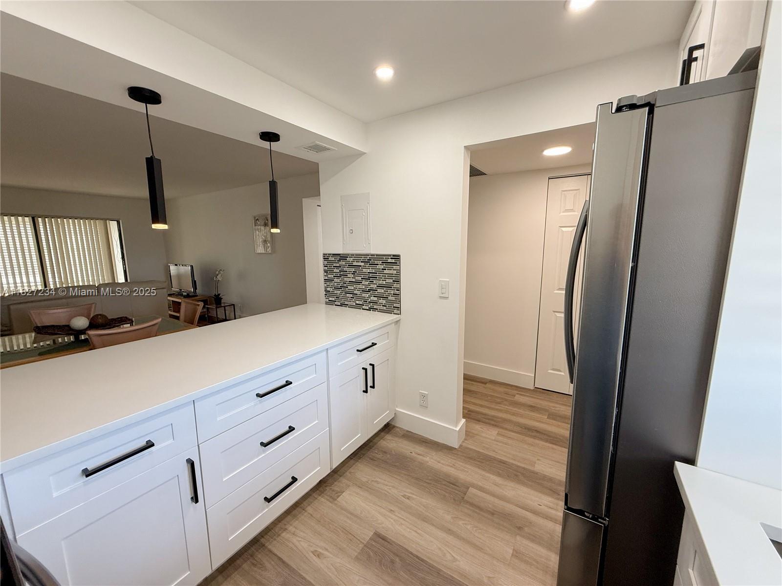 9355 Southwest 8th Street, Unit 402 Boca Raton, FL 33428 - Photo 9 of 29 a bathroom with a double vanity sink and mirror