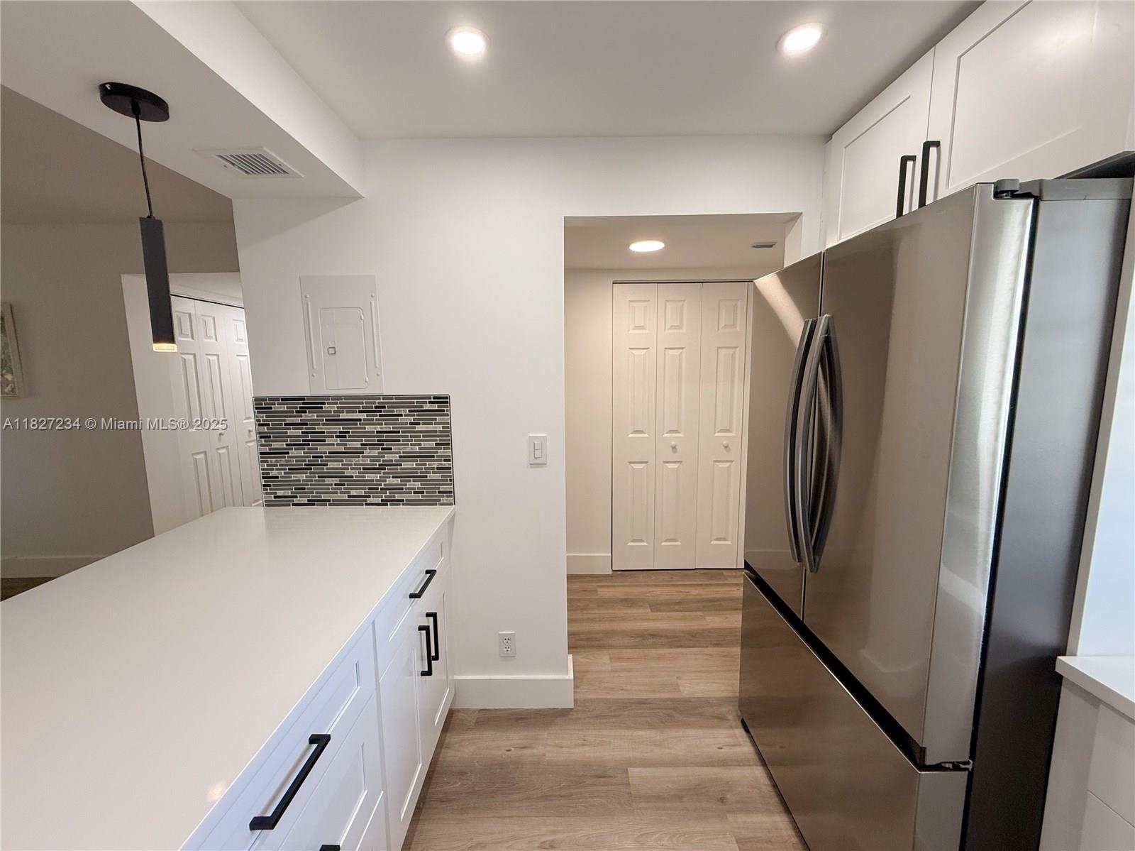 9355 Southwest 8th Street, Unit 402 Boca Raton, FL 33428 - Photo 10 of 29 a kitchen with stainless steel appliances a refrigerator and a sink