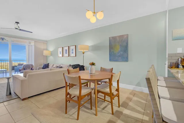 a view of a dining room with furniture and a chandelier