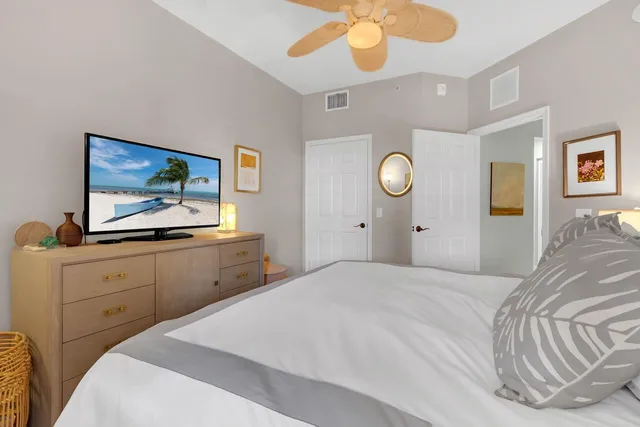 a bedroom with a bed and a chandelier