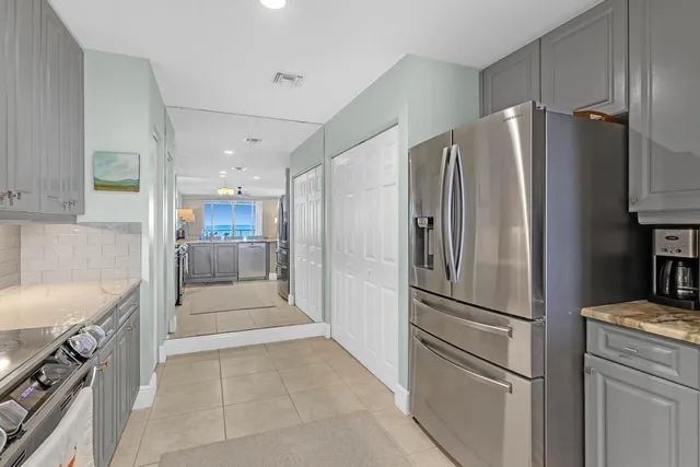 a kitchen with stainless steel appliances granite countertop a refrigerator and a sink